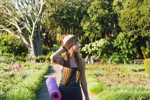 Young woman walking to training in park