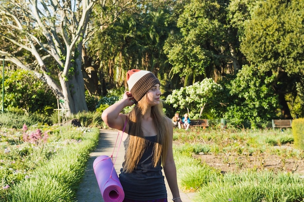 Young woman walking to training in park