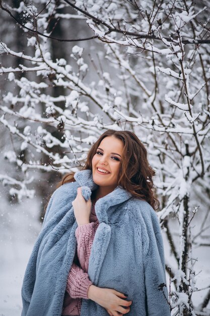 Young woman walking in a winter park