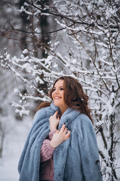 Young woman walking in a winter park