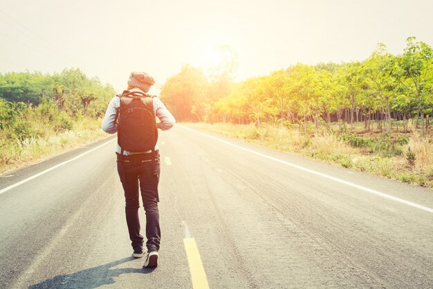 Young woman walking with her backpack