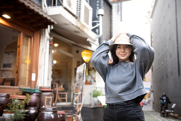 Young woman wearing a bucket hat in the city