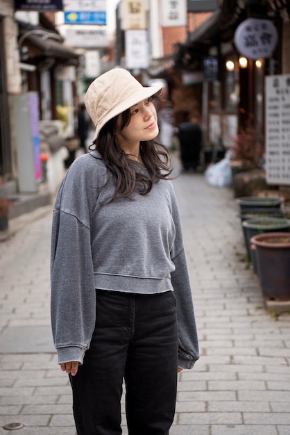 Young woman wearing a bucket hat in the city