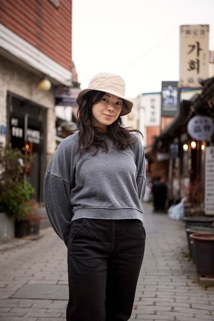 Young woman wearing a bucket hat in the city