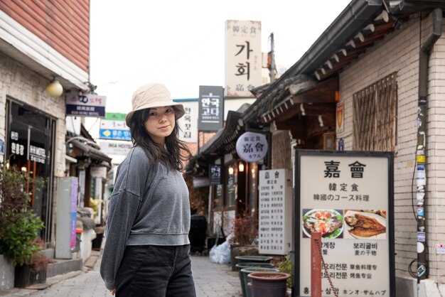Young woman wearing a bucket hat in the city