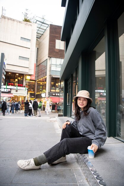 young woman wearing a bucket hat in the city
