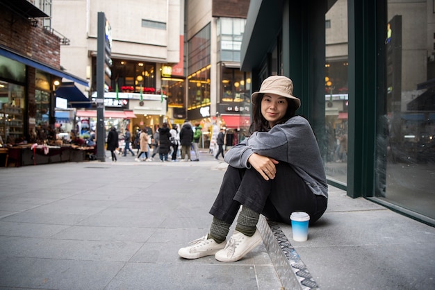 Young woman wearing a bucket hat in the city
