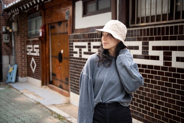Young woman wearing a bucket hat in the city