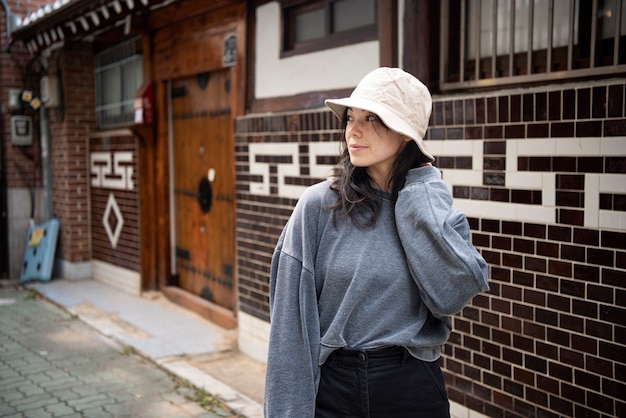 Young woman wearing a bucket hat in the city