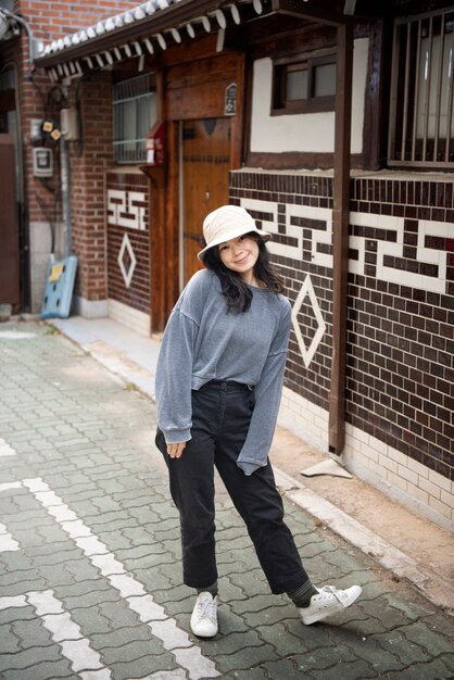 Young woman wearing a bucket hat in the city