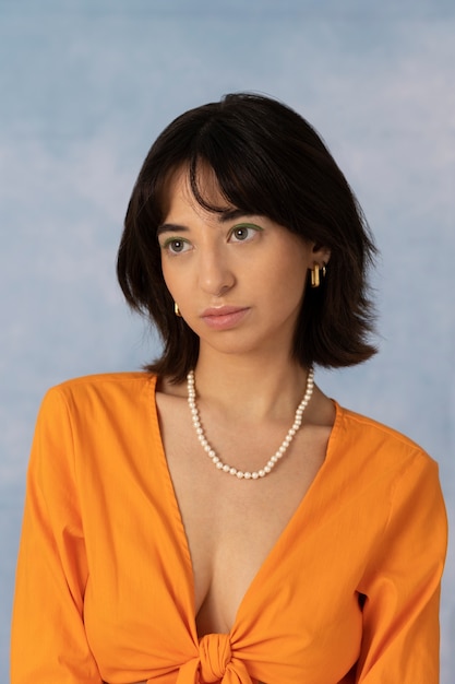 Free photo young woman wearing chain necklace