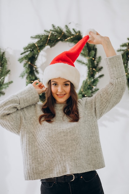 クリスマスにクリスマスの帽子をかぶって若い女性