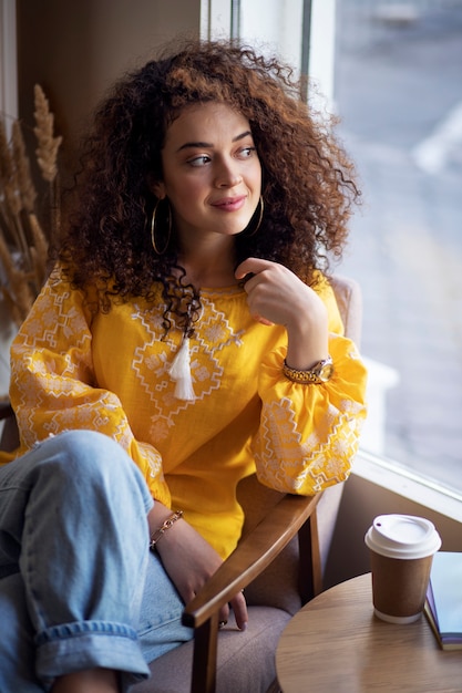 Free photo young woman wearing embroidered shirt