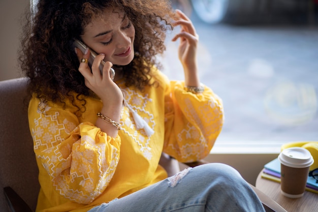 Free photo young woman wearing embroidered shirt