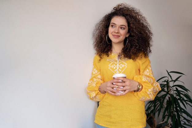 Free photo young woman wearing embroidered shirt