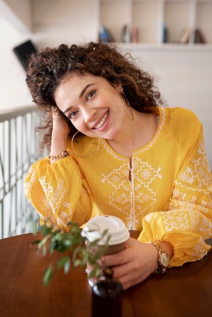 Free photo young woman wearing embroidered shirt