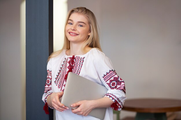 Young woman wearing embroidered shirt