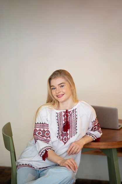 Young woman wearing embroidered shirt