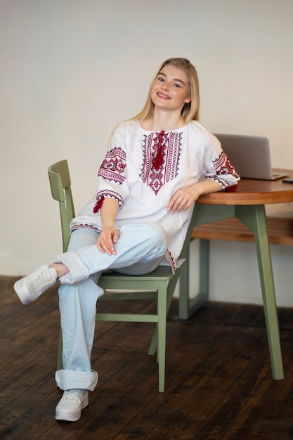 Young woman wearing embroidered shirt