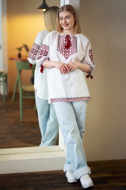 Young woman wearing embroidered shirt