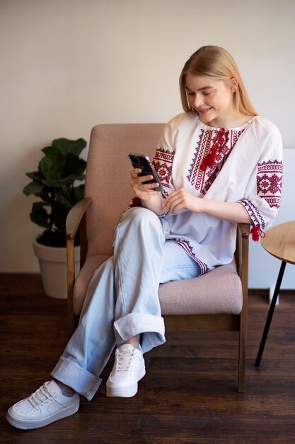 Young woman wearing embroidered shirt