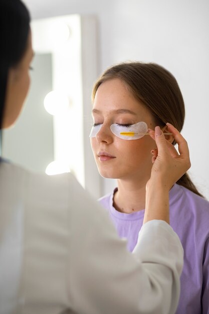 Young woman wearing eye patches side view