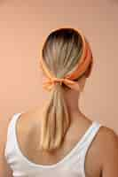 Free photo young woman wearing a handkerchief as a hair accessory