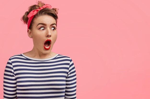 Young woman wearing headband and striped blouse