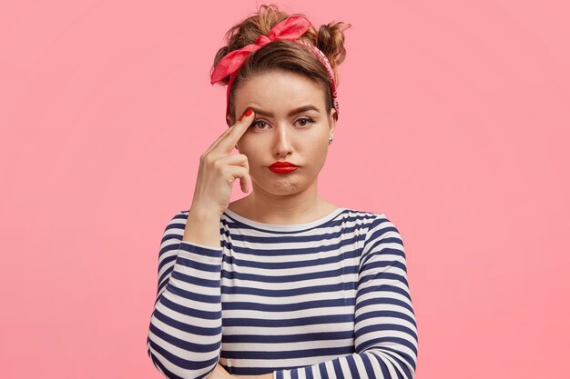 Young woman wearing headband and striped blouse