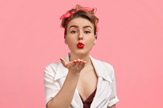 Young woman wearing headband and white blouse