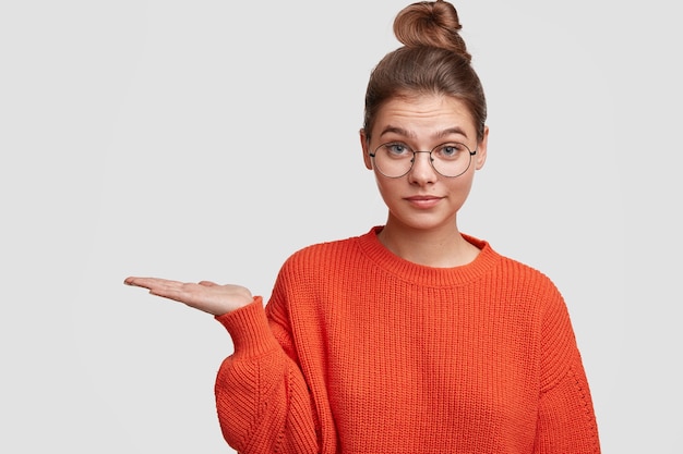 Young woman wearing her hair in a bun and large sweater