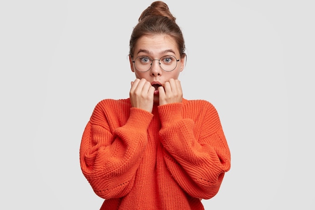 Young woman wearing her hair in a bun and large sweater