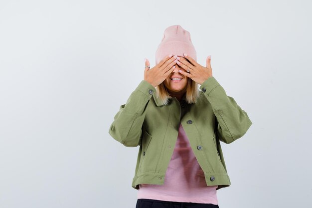 Free photo young woman wearing a jacket covering her eyes