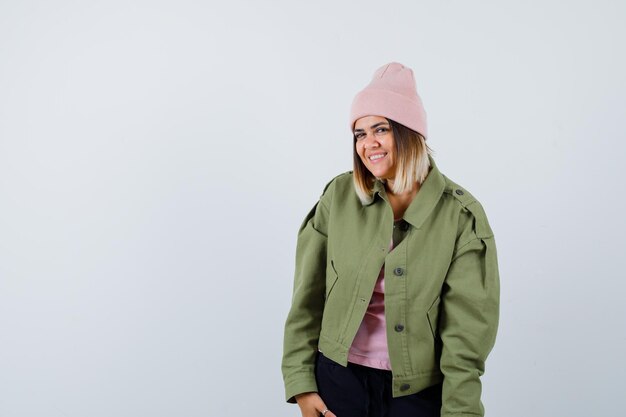 Young woman wearing a jacket and a pink hat