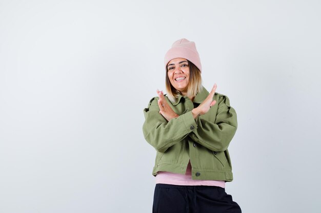 Young woman wearing a jacket and a pink hat