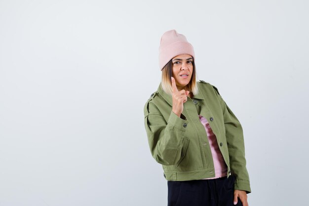 Young woman wearing a jacket and a pink hat