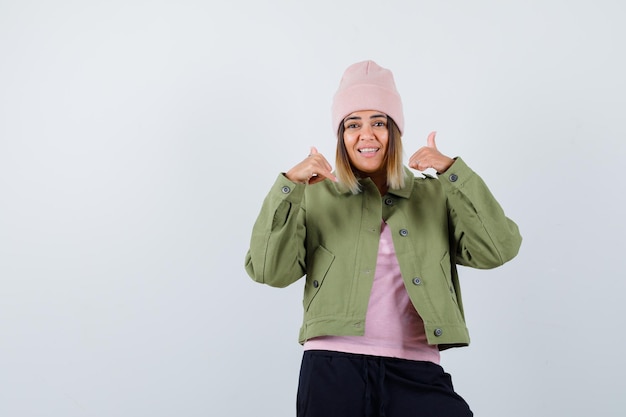 Young woman wearing a jacket and a pink hat