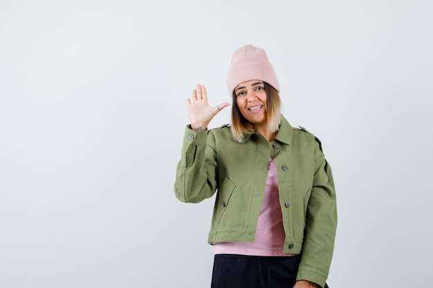 Young woman wearing a jacket and a pink hat