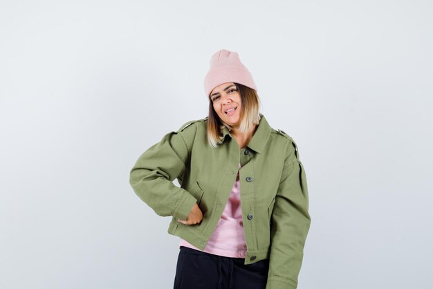 Young woman wearing a jacket and a pink hat