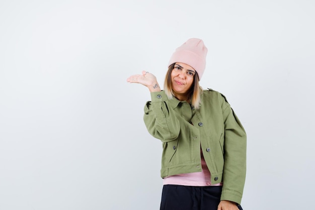 Young woman wearing a jacket and a pink hat