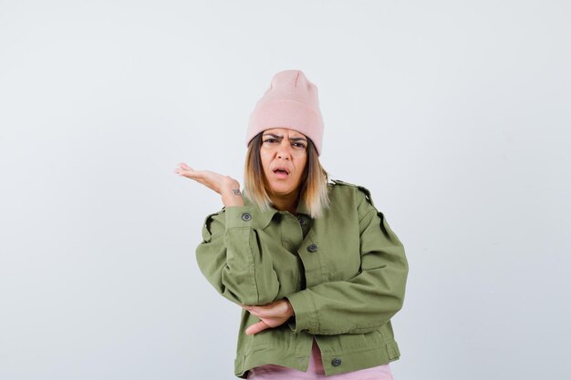 Young woman wearing a jacket and a pink hat