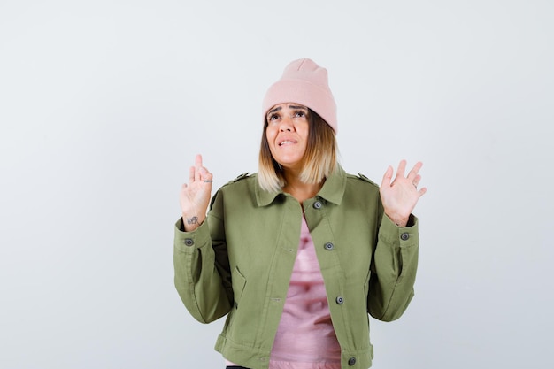 Young woman wearing a jacket and a pink hat