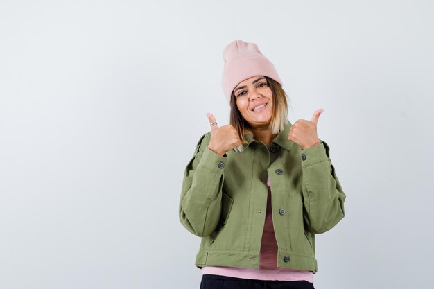 Young woman wearing a jacket and a pink hat