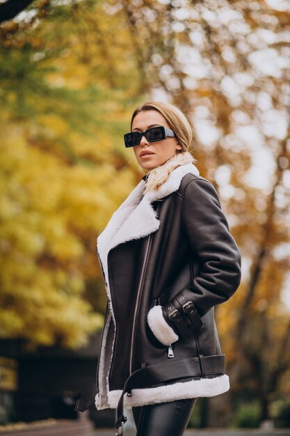 Young woman wearing jacket walking outside