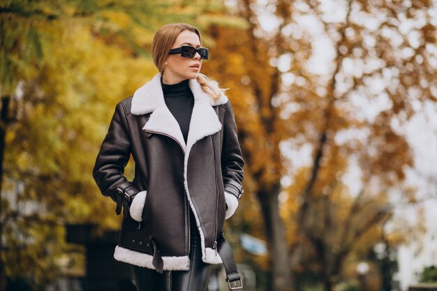 Young woman wearing jacket walking outside