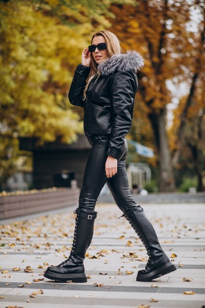 young woman wearing jacket walking outside