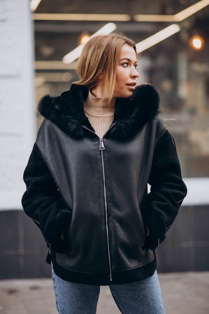 Young woman wearing jacket walking outside