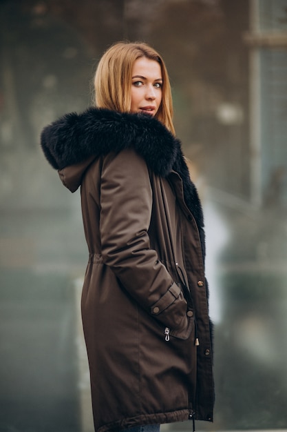 Young woman wearing jacket walking outside