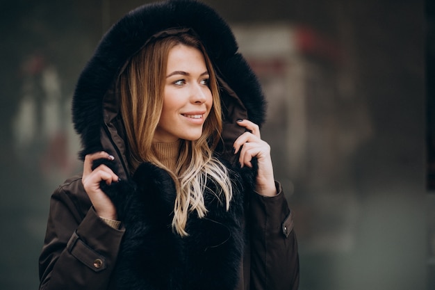 Young woman wearing jacket walking outside