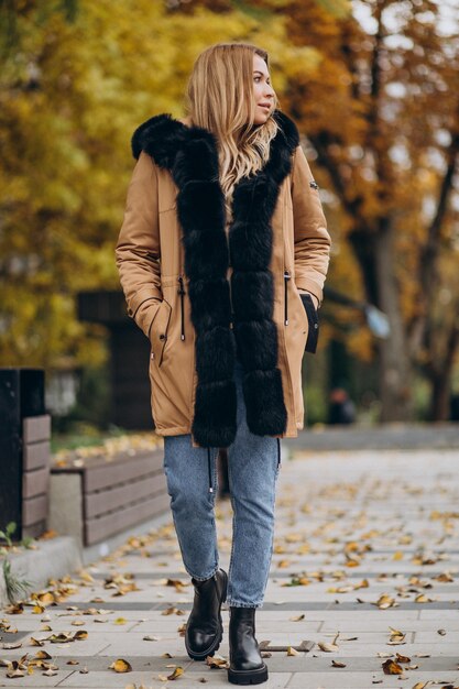 Young woman wearing jacket walking outside